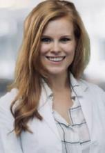 woman with long strawberry blonde hair smiling