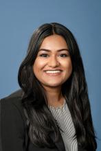woman with long black hair smiling