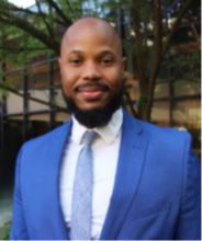 man in bright blue blazer smiling