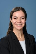 woman with half up, half down hair smiling