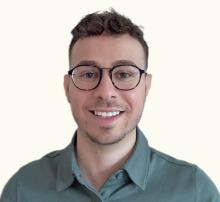 man with round glasses smiling