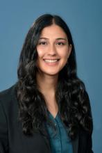 woman with long curly hair smiling