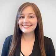 woman with side parted brown hair smiling
