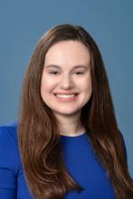 woman with bright blue top on smiling