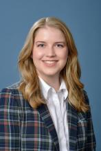 woman in plaid blazer smiling