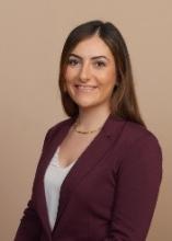 woman with a burgundy blazer on smiling