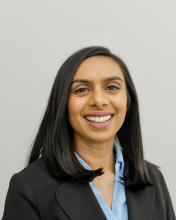 woman with dark shoulder length hair smiling