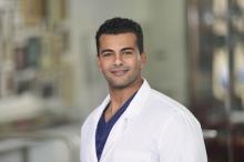 man with short dark hair smiling