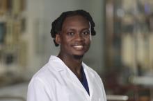 man with short hair and a goatee smiling