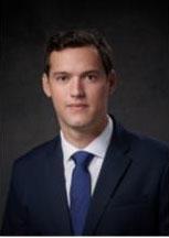 Man smiling in front of grey background