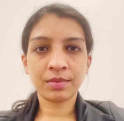 woman with dark hair in a low ponytail smiling lightly