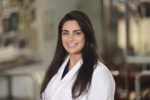 woman with long dark hair smiling
