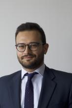 man with glasses and short hair smiling