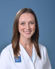woman with brown, shoulder length hair smiling