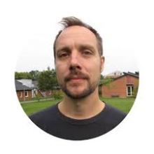 Man smiling in an outside setting