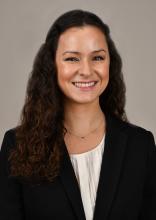 woman with long curly hair smiling