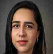 woman with dark hair smiling lightly