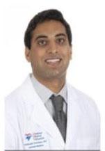 Man smiling in front of white background