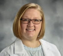 woman with short blonde hair smiling