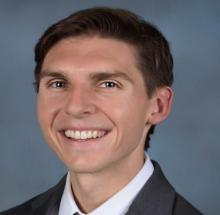 man with short brown hair smiling