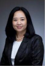 Woman smiling in front of grey background