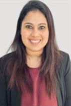 Woman smiling in front of grey background