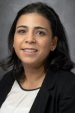 woman with short black hair smiling