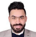 Male with facial hair, smiling. Wearing a light gray suit jacket and dark bow tie