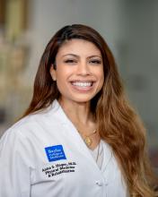 woman with long brown balayage hair smiling