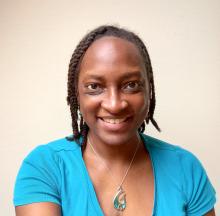 woman in a baby blue tshirt smiling