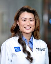 woman with brown highlighted hair smiling