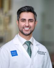 man with salt and pepper hair smiling