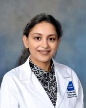 woman with a low ponytail smiling