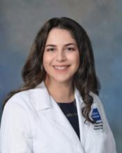 woman with long brown curly hair smiling