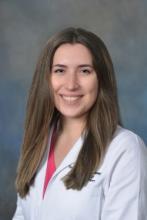 woman with long brown highlighted hair smiling