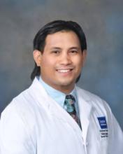 man with dark black hair smiling