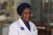 woman in a white doctor coat smiling