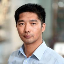 man with short dark hair and a light blue shirt on