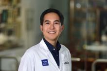 man with short dark hair smiling