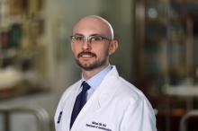 man with glasses smiling