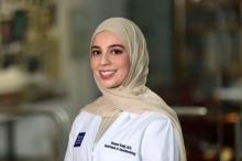 female doctor in a head scarf smiling