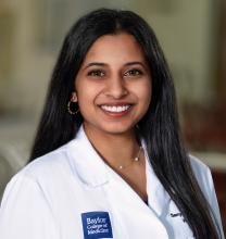woman with long, straight dark hair smiling