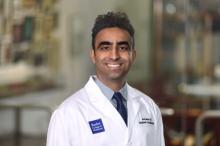 man in white doctor coat smiling