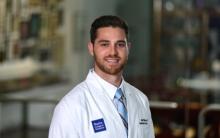 man with brown hair smiling