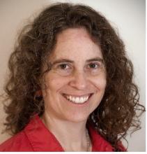 woman with brown curly hair smiling