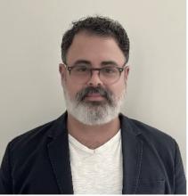 man with a beard and glasses on smiling