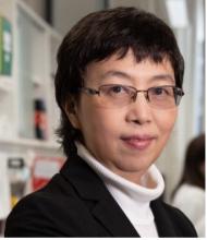 woman with short dark hair and glasses on smiling