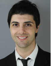 man with black short hair smiling