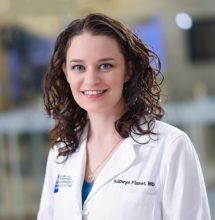 woman with brown curly hair smiling