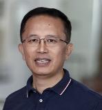 man with short hair and glasses on smiling